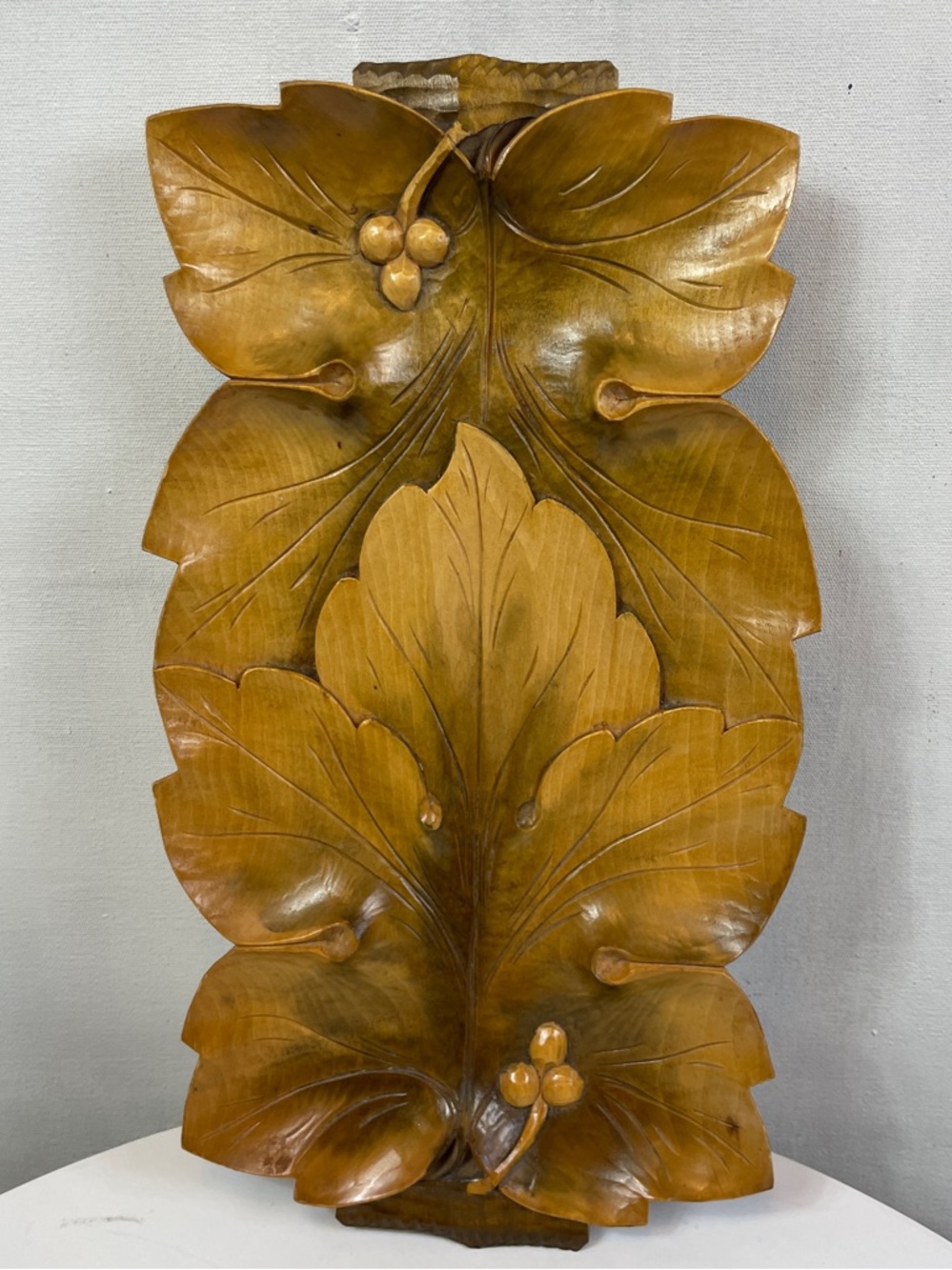 Hand carved wooden serving tray with leaves and berries
